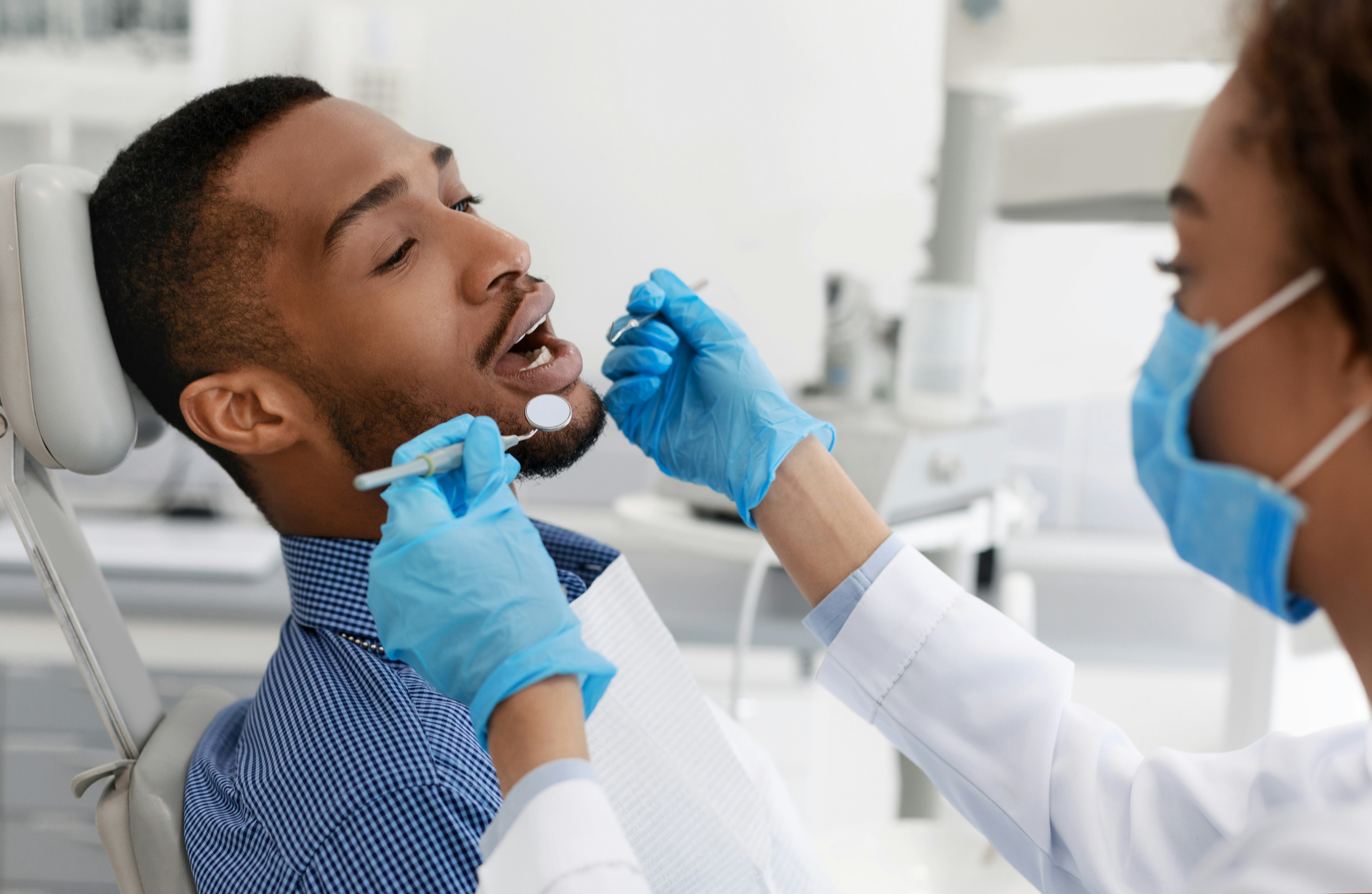 man getting his teeth examined