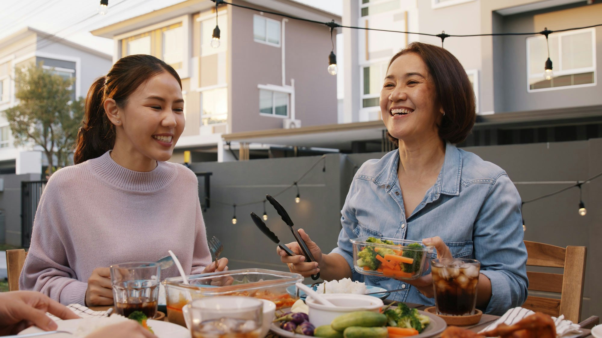 happy women sharing a meal on the back patio