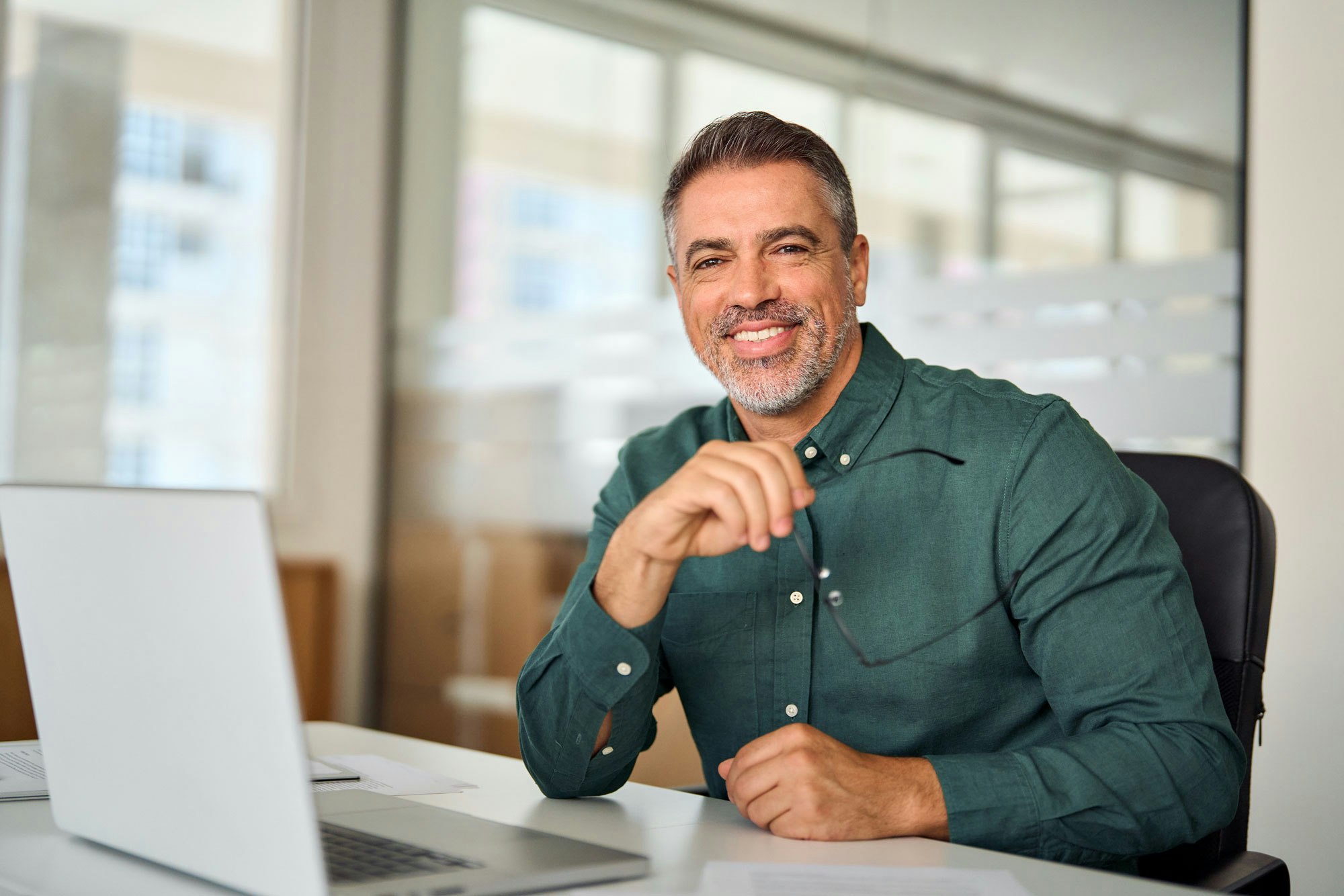 smiling man working on laptop