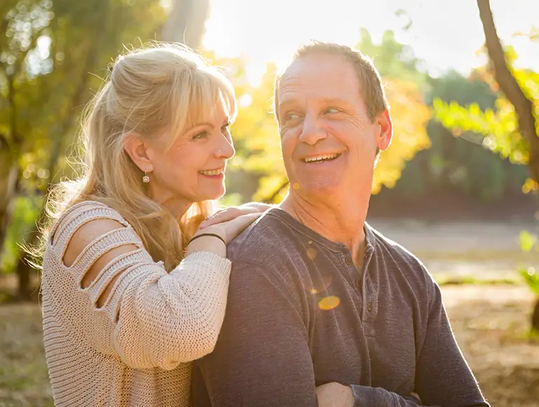 Smiling patient discussing dental implant cost