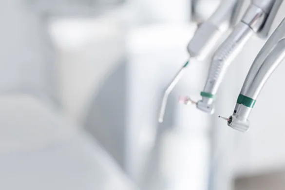 Close-up of tooth implant screw implanted in gums without crown