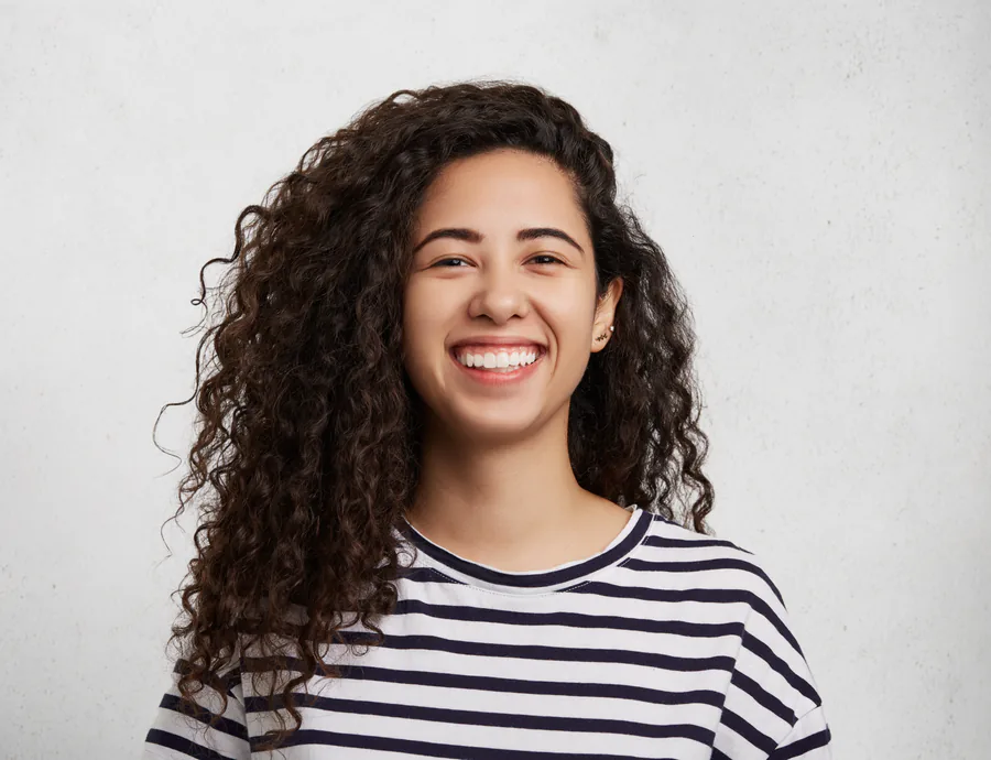 dentist with patient looking in handheld mirror